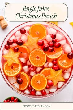 an orange christmas punch in a bowl with ice and cranberries