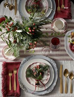 the table is set with silverware and red napkins