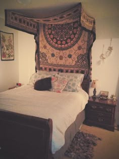 a bed with lots of pillows on top of it