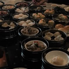 several bowls filled with food sitting on top of a table