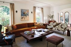 a living room filled with furniture and windows