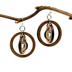 "These gyroscope circle earrings appear simple but possess constantly changing visual intrigue. Three concentric circles encompass one another, creating multiple facets with continual movement and interest. Three tones of wood - walnut, cherry, and maple - add further texture and detail. Laser cut wood earrings can be dressed up or down, making them the perfect complement to any outfit! These earrings are strong but so lightweight and comfortable, you will hardly know you have them on! Pair with Modern Small Hoop Brown Earrings, Modern Brown Small Hoop Earrings, Modern Brown Round Jewelry, Laser Cut Wood Earrings, Laser Cut Earrings, Concentric Circles, Cut Earrings, Printed Jewelry, Silver Dangle Earrings