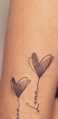 two heart balloons with the word love tattooed on their legs, one has a balloon in the shape of a heart