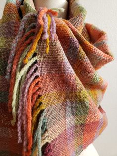 a multicolored shawl on a mannequin