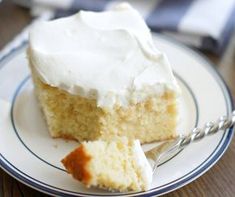 a piece of cake sitting on top of a white and blue plate with a fork