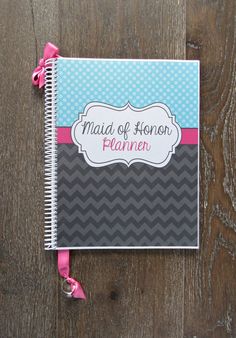 a spiral notebook with the words maid of honon planner on it sitting on a wooden surface