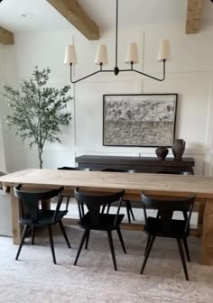 a dining room table with four chairs around it