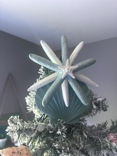 a starfish ornament on top of a christmas tree