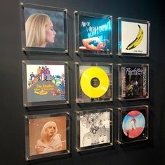 the wall is filled with various records and cds