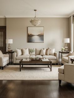 a living room filled with furniture and a chandelier