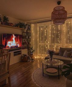 a living room filled with furniture and a flat screen tv sitting on top of a wooden floor