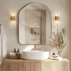 a bathroom with a sink, mirror and towels on the counter in front of it