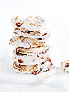 a stack of doughnuts sitting on top of a pile of white powdered sugar