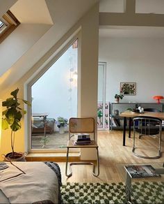 an attic bedroom with a bed, desk and chair in it's center area