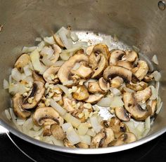 mushrooms and onions cooking in a pan on the stove