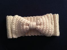 a crocheted bow tie on a black surface