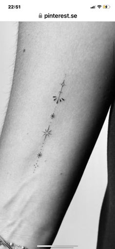 a woman's arm with a small star tattoo on the left side of her leg