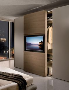 an image of a room with a tv on the wall and closets in it