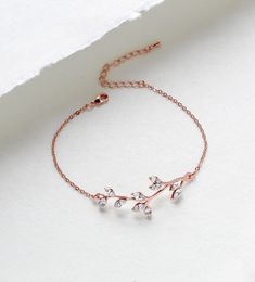 So lovely and delicate.  I created this bracelet in rose gold finish with Premium European crystals.  A romantic leaf design perfect for weddings or everyday.   Bracelet pictured measures 6 inches and extends to 8 inches. Bracelet is .5 inch wide. PLEASE ALLOW APPROX 7 BUSINESS DAYS FOR COMPLETION BEFORE SHIPPING This is an original design by © Treasures by Agnes MATCHING PIECES: https://www.etsy.com/listing/485297202/bridesmaid-necklace-rose-gold-necklace?ref=shop_home_active_2 https://www.etsy.com/listing/511298012/rose-gold-earrings-crystal-bridal Feel free to contact me with any questions !  Thank you for visiting ! Treasures570  Back to main page of Treasures570 for more beautiful designs https://www.etsy.com/shop/treasures570?ref=hdr_shop_menu All pieces come beautifully gift wrapped Elegant Rose Gold Crystal Bracelet For Anniversary, Delicate Rose Gold Cubic Zirconia Bracelets, Elegant Gold Crystal Bracelet As Bridesmaid Gift, Elegant Gold Crystal Bracelet For Bridesmaids, Dainty Rose Gold Diamond Bangle Bracelet, Dainty Rose Gold Chain Bracelet With Cubic Zirconia, Dainty Rose Gold Cubic Zirconia Chain Bracelet, Delicate Rose Gold Bracelets For Bridesmaids, Delicate Rose Gold Bracelet For Bridesmaids