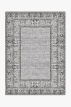 an area rug in grey and beige with a border on the center, surrounded by small white flowers