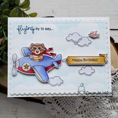 a handmade birthday card with a teddy bear on an airplane