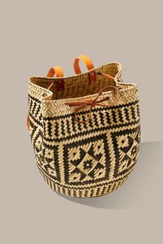 a woven basket with orange handles is shown