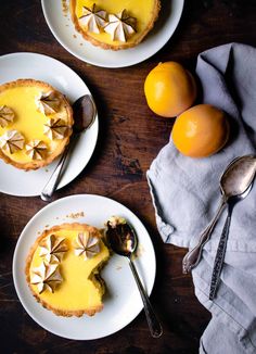 three plates with pies and oranges on them