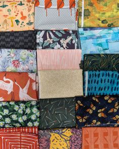 an assortment of different colored fabrics on display