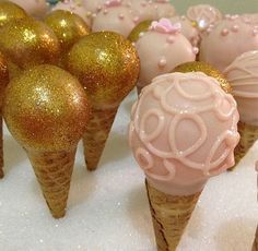 some ice cream cones with pink and gold decorations