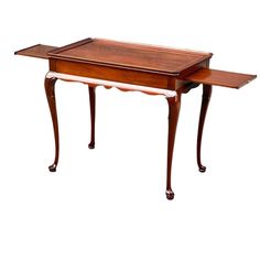 an antique wooden table with two trays on it's legs and one drawer at the top