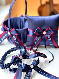 two wedding garters are sitting on a table next to each other with ribbons tied around them