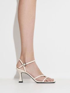 Every wardrobe needs an elegant pair of sandals, and these timelessly versatile strappy sandals are the perfect choice. The soft chalk finish pairs well with delicate straps across the vamps for a feminine silhouette, while adjustable ankle straps offer a customised fit. Featuring sleek 7.5cm trapeze heels, they will elongate your frame and add a sculpted element to your everyday outfits. This product is made with water-based faux leather, which requires less energy to produce than regular faux leather. Pollution-free, non-toxic and free of harmful chemicals, it creates a smaller carbon footprint. Faux Leather Heels, Size Chart For Kids, Charles Keith, Carbon Footprint, The Vamps, Ankle Straps, Heel Sandals, Strappy Sandals, Belt Size