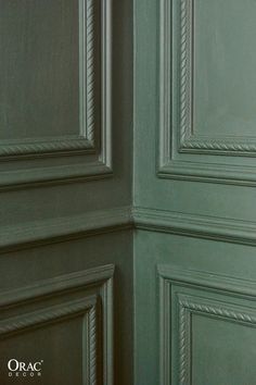 the corner of a room with green painted walls