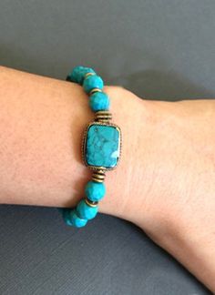 "Turquoise Beaded Bracelet accented with natural brass. Perfect gift for Loved ones or yourself. *Large rectangular Turquoise beads measures approx. 17mm x 14mm *Turquoise Bead measures approx. 8mm **If given a turquoise by a loving friend, that stone would protect the wearer from negative energy and bring good fortune. The turquoise is the symbol of friendship. It also brings peace to the home. This lovely bracelet will come to you or your special someone in a nice gift box. ------------------- Handmade Rectangular Turquoise Bracelets, Bohemian Hand Wrapped Rectangular Jewelry, Hand Wrapped Rectangular Bohemian Jewelry, Adjustable Turquoise Stretch Bracelet With Natural Stones, Adjustable Turquoise Stretch Bracelet For Jewelry Making, Bohemian Blue Beaded Bracelets With Rectangular Beads, Blue Rectangular Beaded Bohemian Bracelets, Blue Rectangular Bohemian Beaded Bracelets, Bohemian Turquoise Rectangular Jewelry