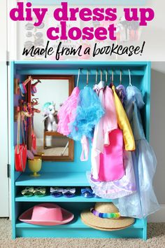 a blue bookcase with clothes hanging on it and the words diy dress up closet made from a bookcase