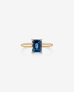 Be the centre of attention with this understated yet luxurious london blue topaz ring. Featuring a striking emerald cut topaz centre set in 10kt yellow gold, this magnificent ring is perfect for making a statement. Heirloom Gold Topaz Ring With Blue Topaz, Blue Topaz 14k Gold Ring, Gold Emerald-cut Topaz Ring In 14k Gold, Luxury Emerald-cut Yellow Gold Topaz Ring, Blue Emerald-cut Topaz Ring In 14k Gold, Blue Topaz Bracelet