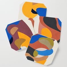 three coasters with abstract designs on them