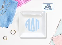 a white plate with the word ad on it next to some scissors and other crafting supplies