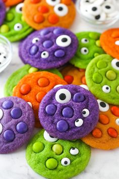 colorful cookies with googly eyes are on the table