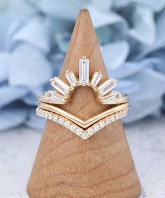 a diamond ring on top of a wooden stand