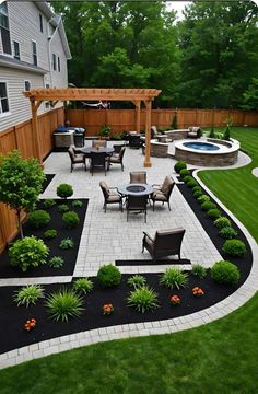 an outdoor patio with chairs, table and fire pit in the middle of grassy area