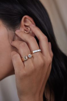 a woman wearing a gold and diamond ring