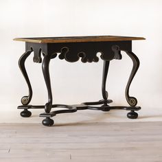 an antique table with two legs and a wooden top on casteors is shown against a white background