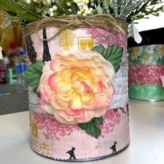 a flower pot with flowers in it sitting on a table