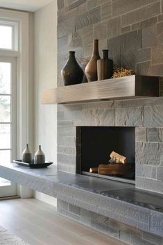 a fireplace with some vases on top of it