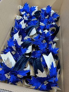 a cardboard box filled with blue and white flowers