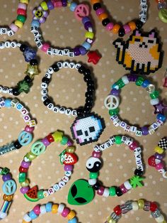 Five random kandi bracelets made with love! Each kandi is custom, cute, and quality! The mix of kandi will include: 1 bracelet with a medium/large perler charm attached  1 bracelet with a small perler charm attached 3 singles with various phrases and specialty beads  some bracelets/phrases will not be family friendly message me for any custom requests and I will try to accommodate! Kandi Display, Kandi With Perler, Kandi Bracelets Ideas Singles, Bracelet Inspo Aesthetic, Rave Kandi Bracelets Ideas, Kandi Quotes, Kandi Phrases, Kandi Bracelets Patterns, Kandi Ideas Words