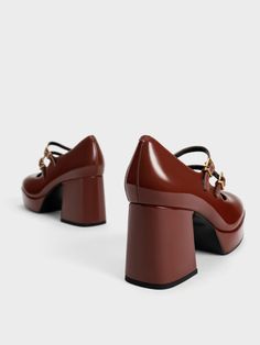 Channel old-school glamour with these vintage-inspired Mary Janes. A classy design set on sturdy block heels, these shoes offer effortless versatility and comfortable all-day wear. In flattering cognac with a high-shine finish, they will complement, and add a subtle shine, to a wide range of outfits. Style them with crop blazers and mini-skirts for a quirky and youthful after-dark look. Trendy Formal Block Heels With Round Toe, Trendy Formal Block Heels With Reinforced Heel, Retro Brown Heels With Block Heel, Brown Mary Jane Heels For Office, Trendy Patent Leather Block Heels For Formal Occasions, Modern Brown Heels With Contrasting Heel Counter, Elegant Brown Block Heels For Fall, Trendy Brown Heels With Sculpted Heel, Brown Block Heel Shoes For Work