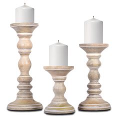 three white candles sitting next to each other