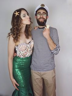 a man and woman dressed up as mermaids